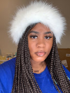 Person wearing a white furry headband with a neutral background