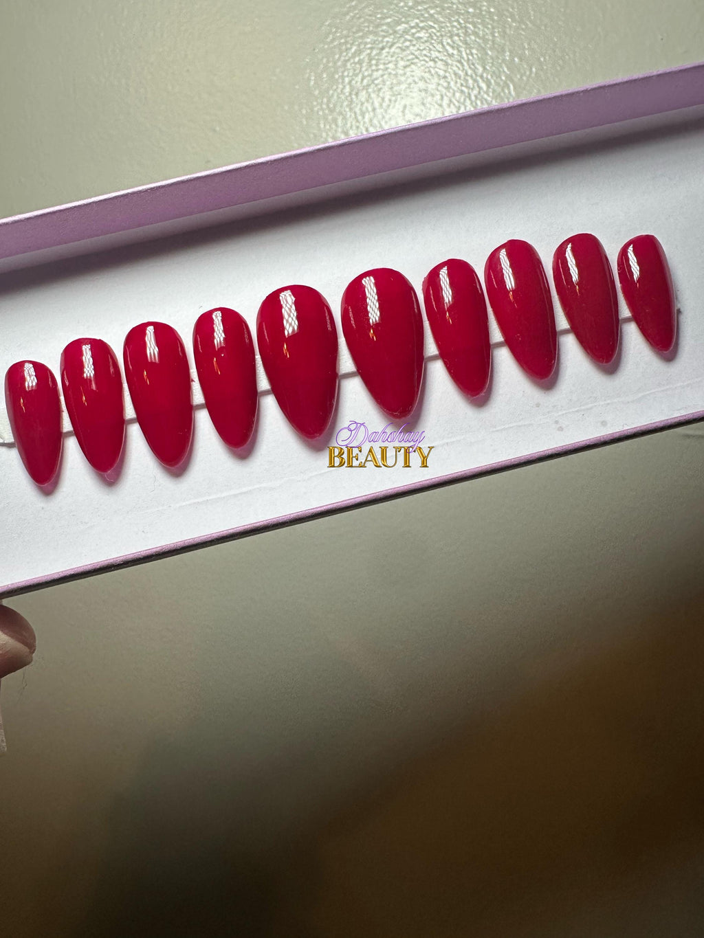 Set of red press on nails on a plain background.
