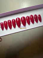 Set of red press on nails on a plain background.