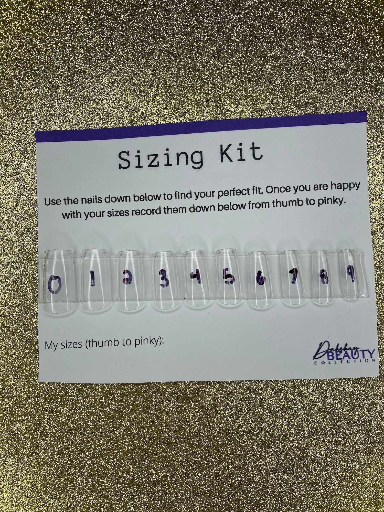 Sizing kit for false nails with measurement chart on a glittery background