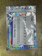 Holographic packaging of a 'Sizing Kit' with measurement tools on a textured gold background.
