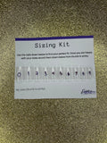 Nail sizing kit with clear nail forms and measurement labels on a gold glitter background.