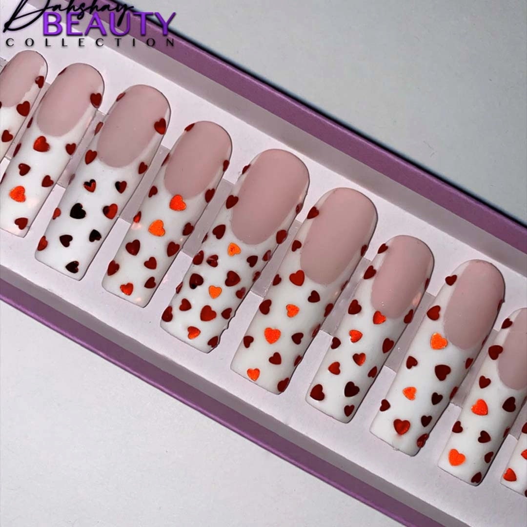 Set of false nails with heart patterns in a box labeled 'Dahshay Beauty Collection'.