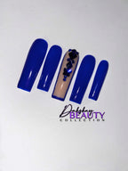 Blue nails with a rhinestone design on a plain white background