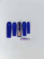 Blue nails with a rhinestone design on a plain white background