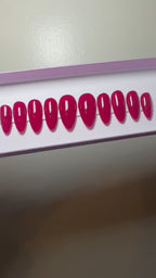 Set of red press on nails on a plain background.