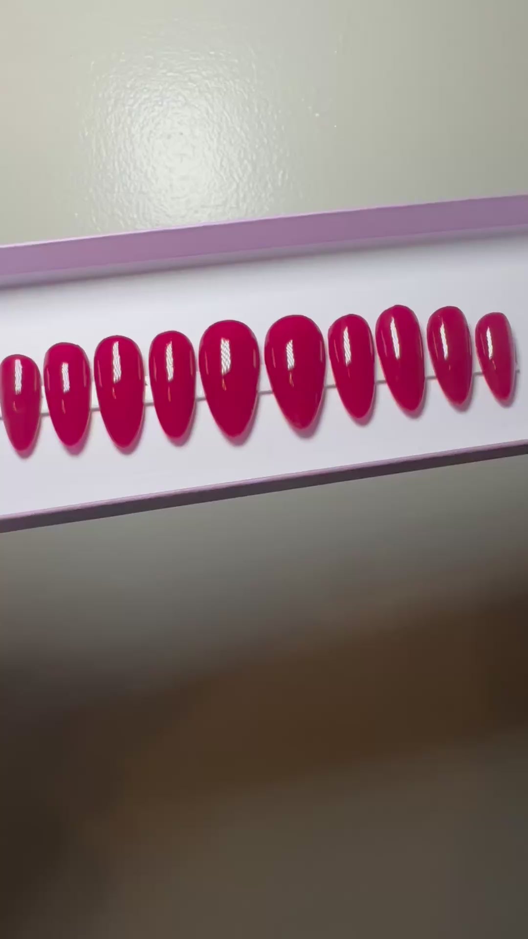 Set of red press on nails on a plain background.